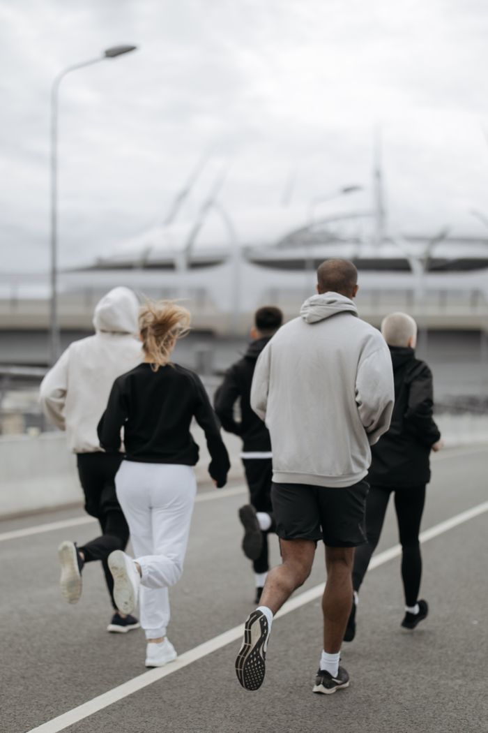 The Art of Drawing Readers In: Your attractive post title goes here Five adults jogging outdoors in an urban area, promoting fitness and teamwork.